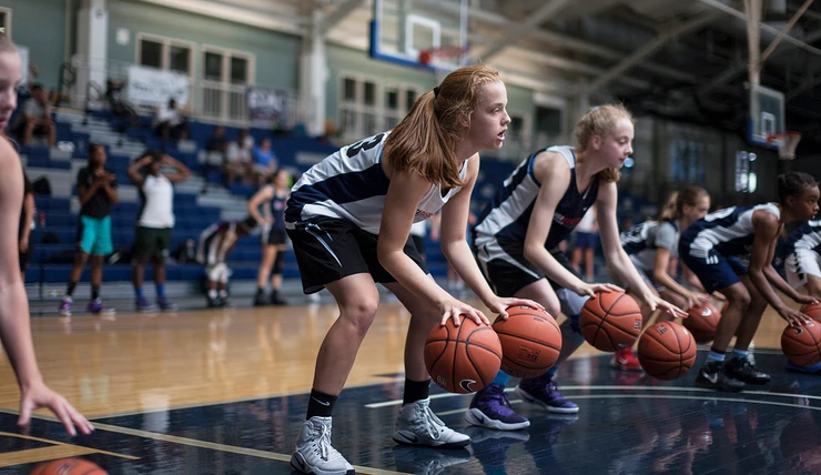 Girl training basketball